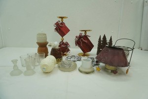 large assortment of candle stands and holders