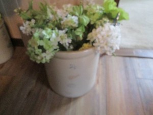 Red Wing 4-gallon Stoneware Crock with metal handles and faux floral picks and butterfly garden marker