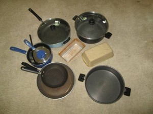 Variety of non-stick cookware pots and pans, some with lids
