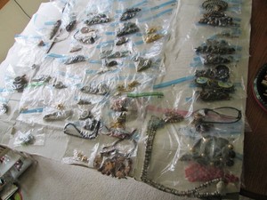 Massive lot of assorted costume jewelry includes necklaces, earrings in a wide variety of styles and materials with the possibility of precious metal content