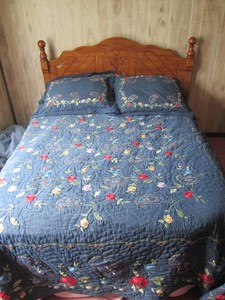 Full size bed and Hardwood Oak style traditional spindle headboard with ornate floral carved details and turned finial posts