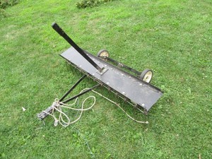 Pull behind lawn dethatcher