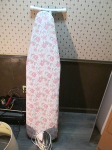 Metal fold up ironing board with Black and Decker steam iron