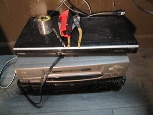 Toshiba DVD player, Panasonic DVD player, and Phillips VHS player with misc shown