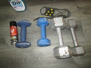 Metal and coated hand weights, ice cleats, Buck bomb doe spray and wallpaper stripper spray