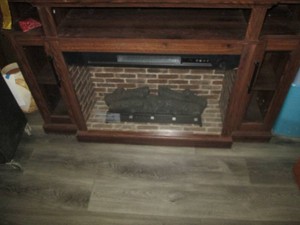Dark wood entertainment console with 30in electric fireplace insert and remote. Unit approx 54in wide