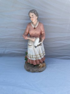 HOMCO LADY HOLDING A COFFEE POT NEXT TO A DOG #29