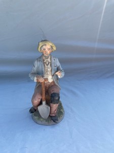HOMCO MAN SITTING ON STUMP HOLDING A PIPE#27