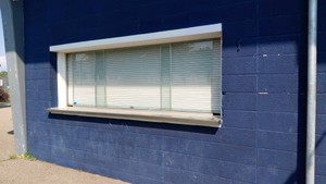 ATLAS ROLL UP SNACK BAR WINDOW WITH STAINLESS STEEL COUNTER TOP.