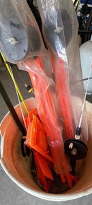 Bucket of fishing supplies and 2 water rafts