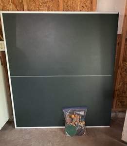 ping-pong table top with paddles and balls