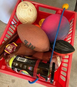 Crate full of assorted ball balls