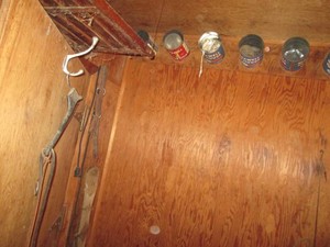 Variety of misc horse tack & accessories on wall and in tin cans