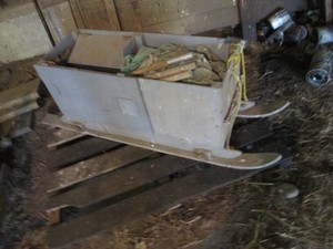 Ice fishermans pull along storage box on snow skis with unknown condition pop-up fishing blind
