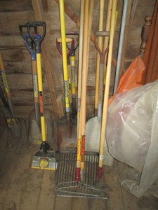 Variety of shovels, pitchforks, rakes and a shingle remover