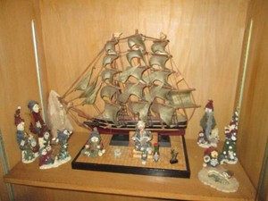 Vintage Carved wood pirate ship with cloth sails and snowman figurine collection