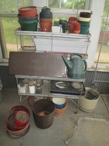 Metal rolling plant stand, watering can, garden stakes and large variety of planters