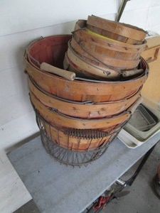 Bundle of wicker bushel baskets with metal wire framed basket