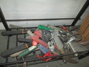 Collection of assorted gardening tools and watering hose accessories