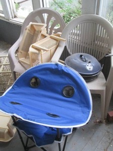 Outdoor patio chairs, fold-up camping table, stacking storage baskets, planter and portable charcoal tabletop grill