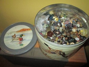 Decorative metal tin loaded with a huge variety of buttons and clothing fasteners