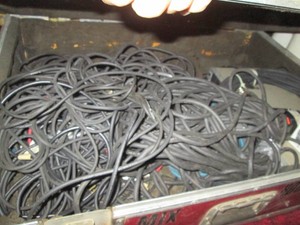 Large Anvil musician case loaded with patch cords and a single microphone