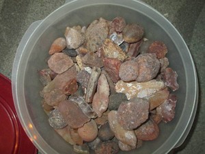 Storage container of assorted raw agate rocks