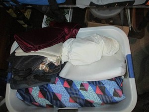 Laundry basket with clothing, air mattress, linens and other misc
