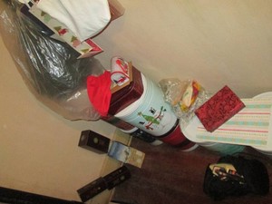 Collectible holiday tins, string lights, gift bags, artificial Christmas tree and more