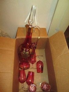 Vintage colored glass decanter and stemware set with gold tonectrim and accents