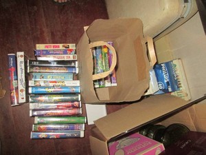 Variety of assorted VHS movies from children to adult plus misc packages of holiday string lights