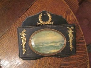 Antique wall mounted wood mail holder with ocean wave front and Brass tone accents