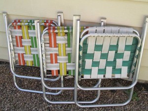 Trio of metal framed vinyl webbed lawn chairs