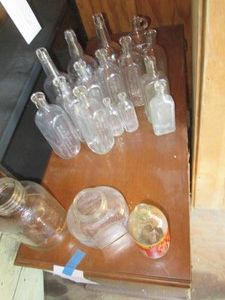 Collection of assorted vintage clear glass bottles