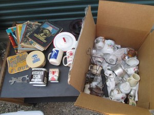 Variety of assorted collectibles including mugs, shot glasses, reading materials and more