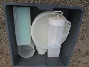 Catering bin with assorted vintage Tupperware food storage containers