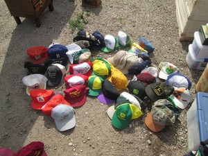 Large collection of John Deere and other assorted trucker caps, snap backs and fitted hats