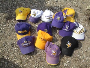 Assortment of MN Vikings baseball hats and other caps