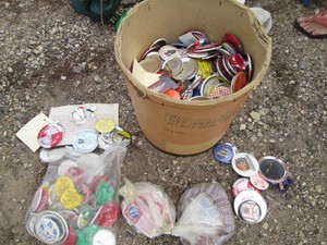 Vintage cardboard bean bucket stocked full of assorted novelty and collectible buttons and pins