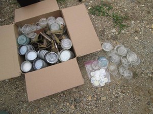 Box of vintage glass and metal canning jar cover variety