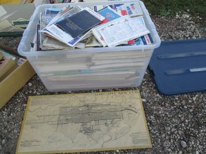 Tote containing a gigantic variety of maps, road atlases and directio al supplies from around the world