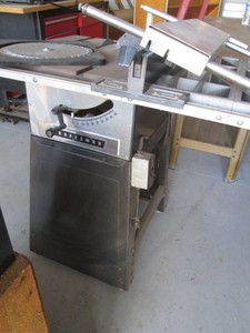 Craftsman table saw with rolling metal stand and attachments shown