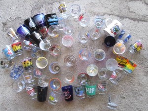 Collection of vintage landmark and sports themed shot glasses
