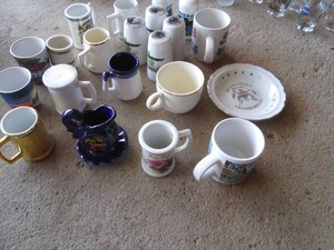 Variety of vintage salt and pepper shakers, shot glasses and assorted collectibles
