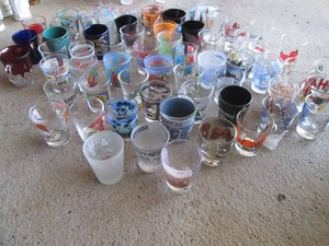 Vintage souvenir shot glasses in varying styles and themes