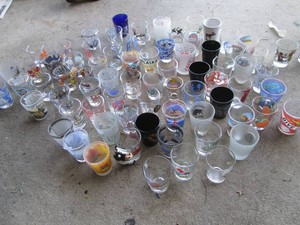 Large variety of vintage shot glasses in assorted styles and themes