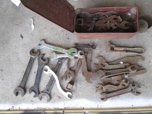 Antique rusty metal hand tools with metal hinged lid box