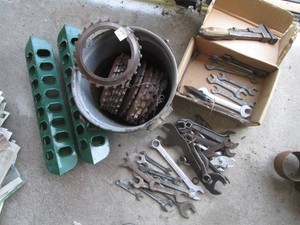 Antique cast iron planter plates with enamelware pail, metal chicken feeders and vintage hand tools