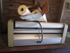 Vintage laminating machine with misc rolls laminating sheets
