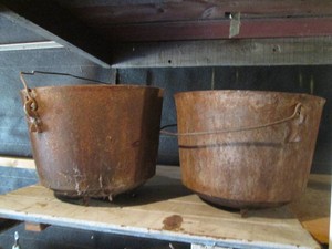 Pair of cast iron open pit style pots